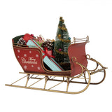 Piros fém szánkó ajándékkal Merry Christmas felirattal